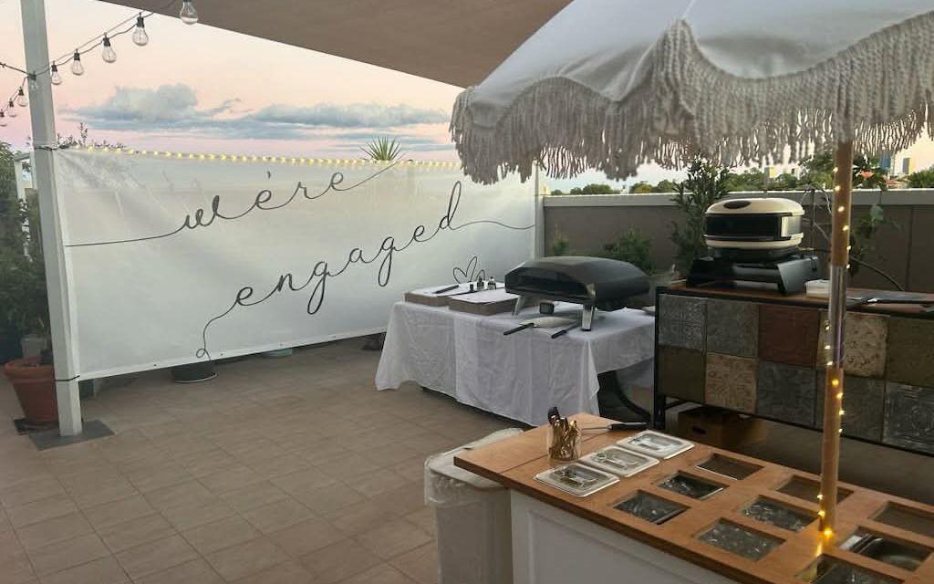 Engagement party with styled event carts and guest gathering