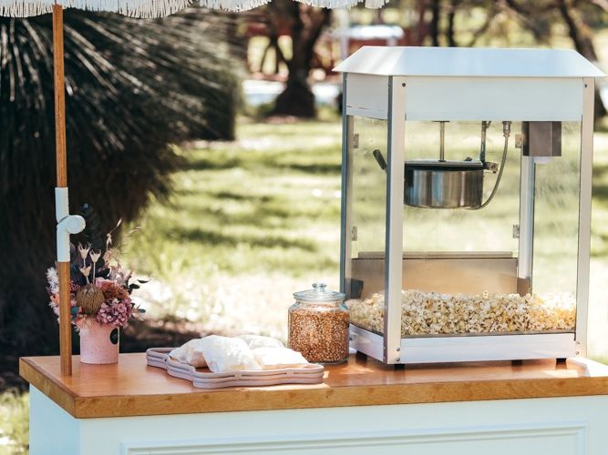 Popcorn cart with branded bags and flavour dusts at celebration