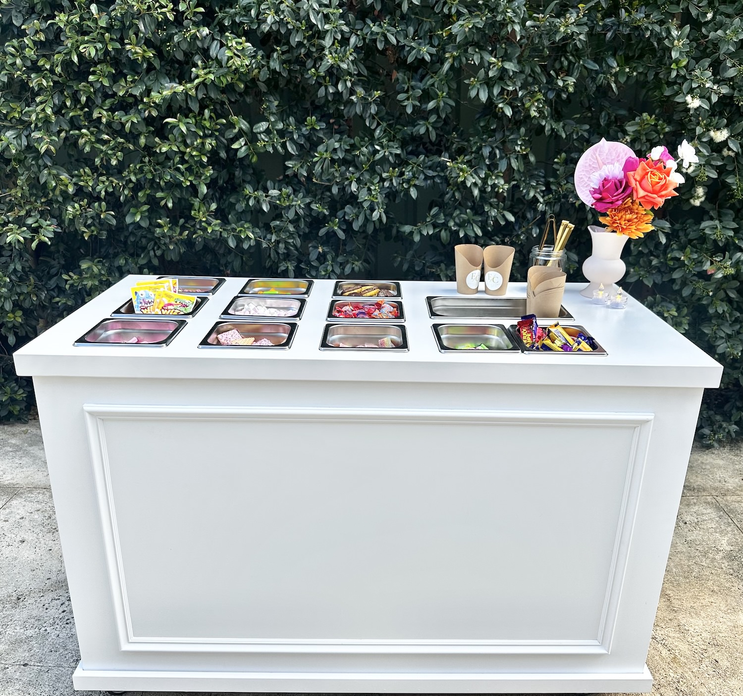Compact grazing cart at beachside park with fringed parasol and gold lettering